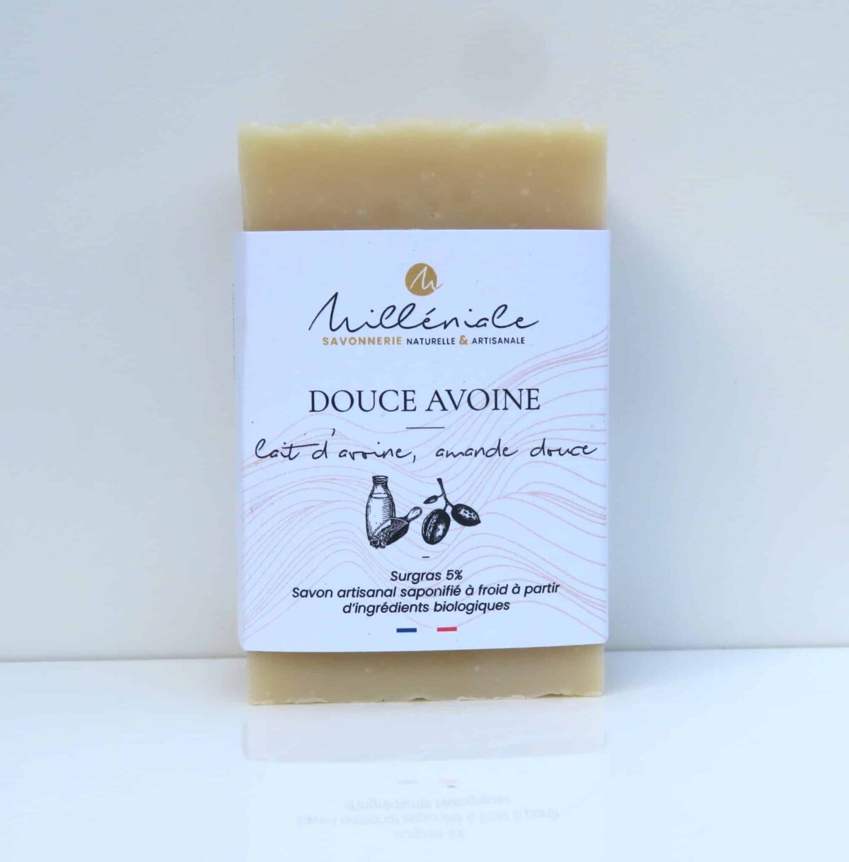 Savon artisanal peau sensible au lait d’avoine et huile d’amande douce avec étiquette, sur fond blanc.